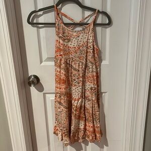 Orange dress with multiple designs cross over in the back of dress